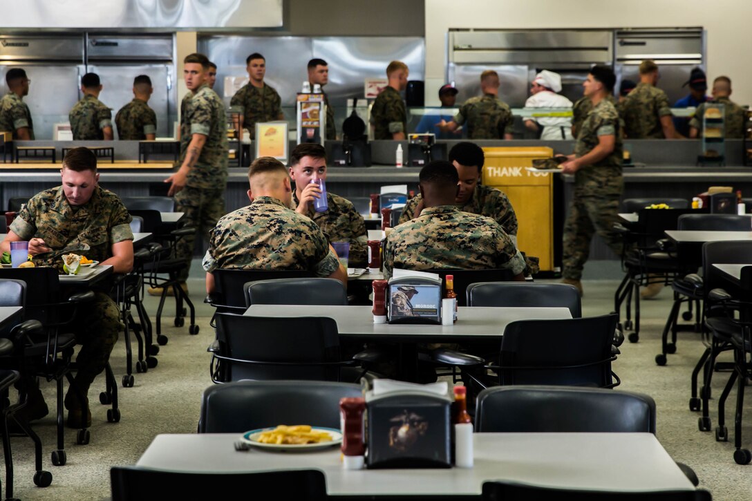 Marines enjoy their meal during the Phelps Mess Hall grand re-opening aboard the Marine Corps Air Ground Combat Center, Twentynine Palms, Calif., June 4, 2018. Phelps Hall has been closed since November 11, 2017, due to renovations to improve the efficiency of the facility. (U.S. Marine Corps photo by Lance Cpl. Margaret Gale)