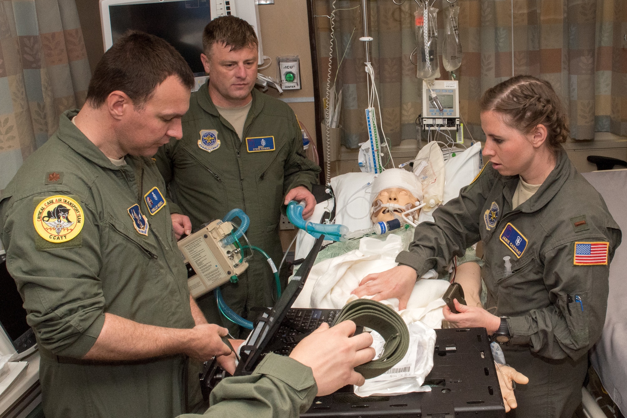 Members of the 151st Air Refueling Wing, Utah Air National Guard, prepare their patient for transfer to a guerney during the Critical Care Air Transport Team training event in Minneapolis, Minn., May 31, 2018. (U.S. Air Force photo by Master Sgt. Eric Amidon)