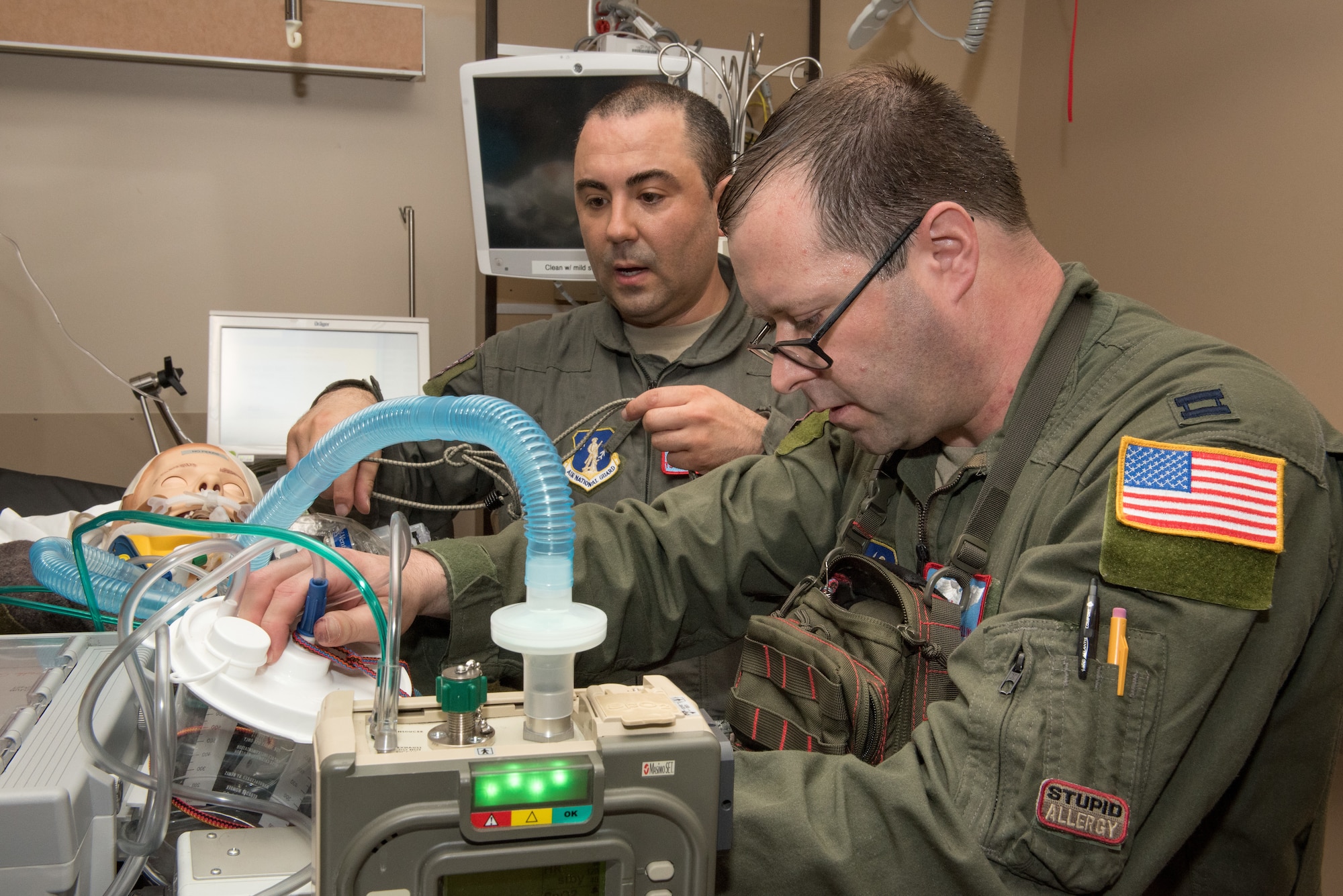 Tech. Sgt. Joseph Costandi, a cardio pulminary tech assists Capt. Kevin Collins, a Critical Care Air Transport physician, both with the Newy York Air National Guard, confirm the equipment is functioning for their patient during a CCATT turnover exercise in Minneapolis, Minn., May 31, 2018. (U.S. Air Force photo by Master Sgt. Eric Amidon)