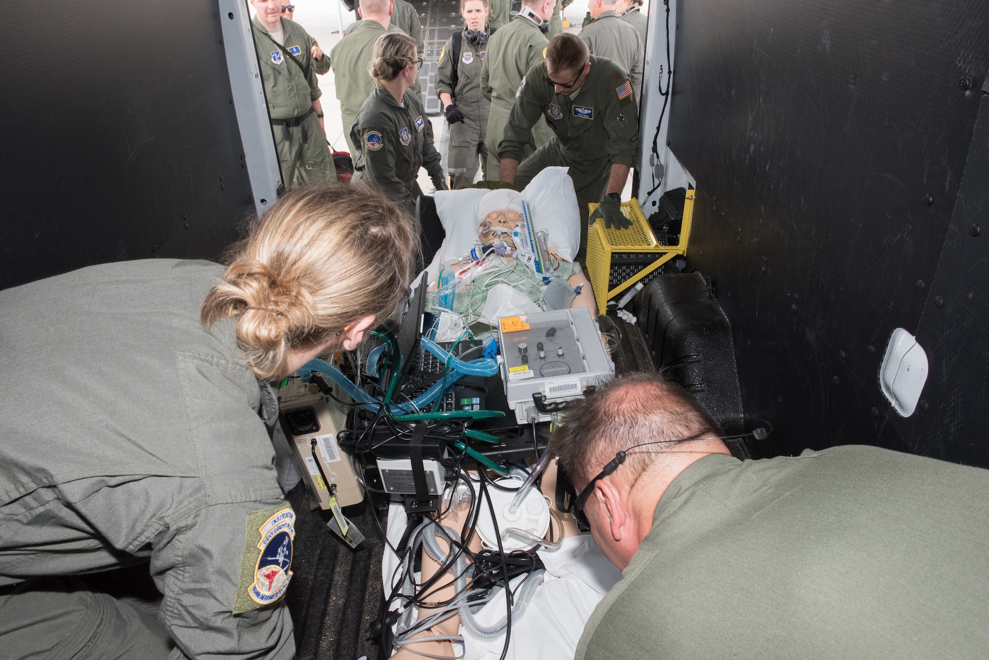 Critical Care Air Transport Team members from the 109th Airlift Wing, New York Air National Guard, and the 151st Air Refueling Wing, Utah ANG, receive the patients from the aircraft upon landing during the CCAT training event at the Minneapolis-St. Paul Air Reserve Station, Minn., May 31, 2018. (U.S. Air Force photo by Master Sgt. Eric Amidon)