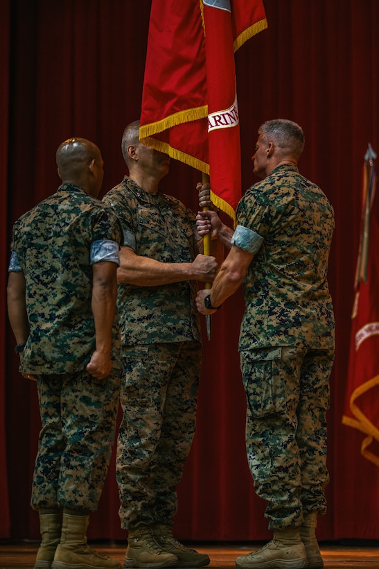 Maj. Gen. William F. Mullen III, off-going commanding general, Marine Corps Air Ground Combat Center, passes the colors to Brig. Gen. Roger Turner, on-coming commanding general, MCAGCC, during the installation’s change of command ceremony aboard the Combat Center, Twentynine Palms, Calif., June 8, 2018. The change of command ceremony ensures that the unit and its Marines are never without official leadership, and also signifies an allegiance of Marines to their unit commander. (U.S. Marine Corps photo by Lance Cpl. Rachel K. Porter)