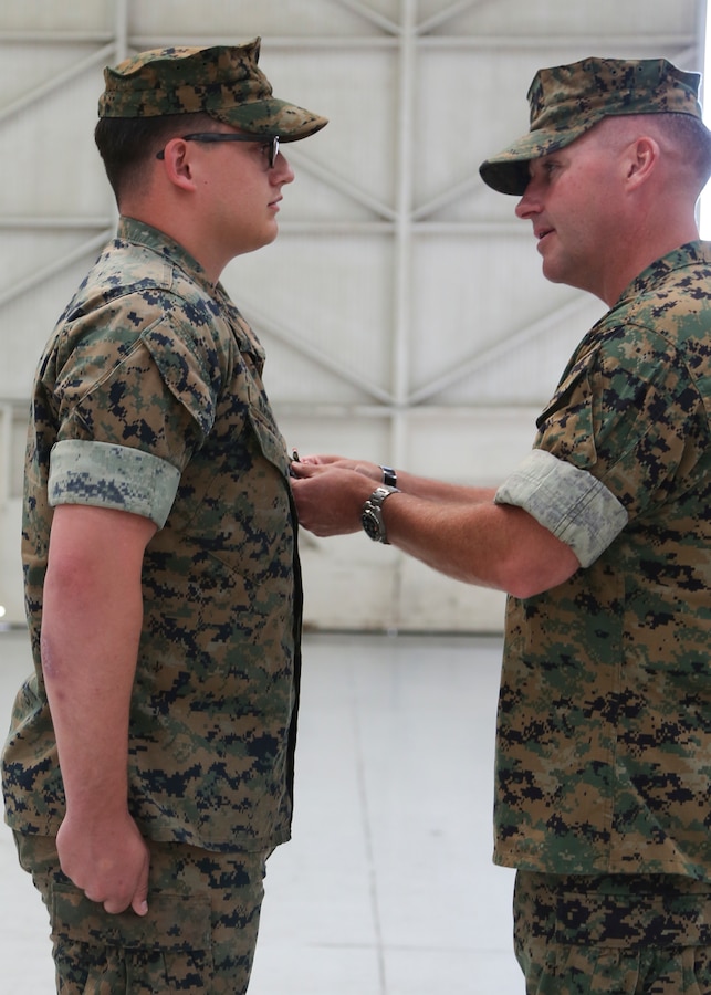 Col. Simon Doran, the Marine Aircraft Group 11 commanding officer, pins the Navy and Marine Corps Medal to Sgt. Nathan Hanbury, an F/A-18 electrical systems technician with Marine All-Weather Fighter Attack Squadron [VMFA(AW)] 225, during a ceremony June 7 at Marine Corps Air Station Miramar, California, for his actions on Aug. 10, 2016. Hanbury, with complete disregard for his own safety, immediately ran into the water at Panama City Beach, Florida, when he saw a teenager struggling to stay above the water. Hanbury encouraged the teenager to keep swimming and helped him back to the safety of the shore. (U.S. Marine Corps photo by Sgt. Brytani Wheeler)
