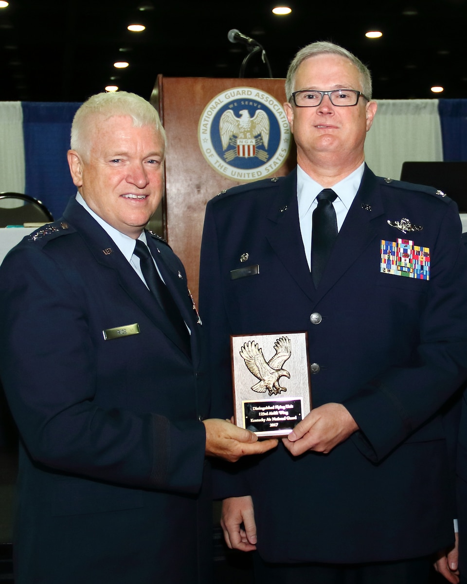 Lt. Gen. L. Scott Rice (left), director of the Air National Guard, presents Col. David Moukes, commander of the 123rd Airlift Wing, with the 2017 National Guard Bureau Distinguished Flying Unit Plaque during the National Guard Association of the United States annual conference Sept. 10, 2017, in Louisville, Ky. The plaque is awarded annually top the top 10 percent of all Air Guard flying units. (Courtesy photo by Jay May)