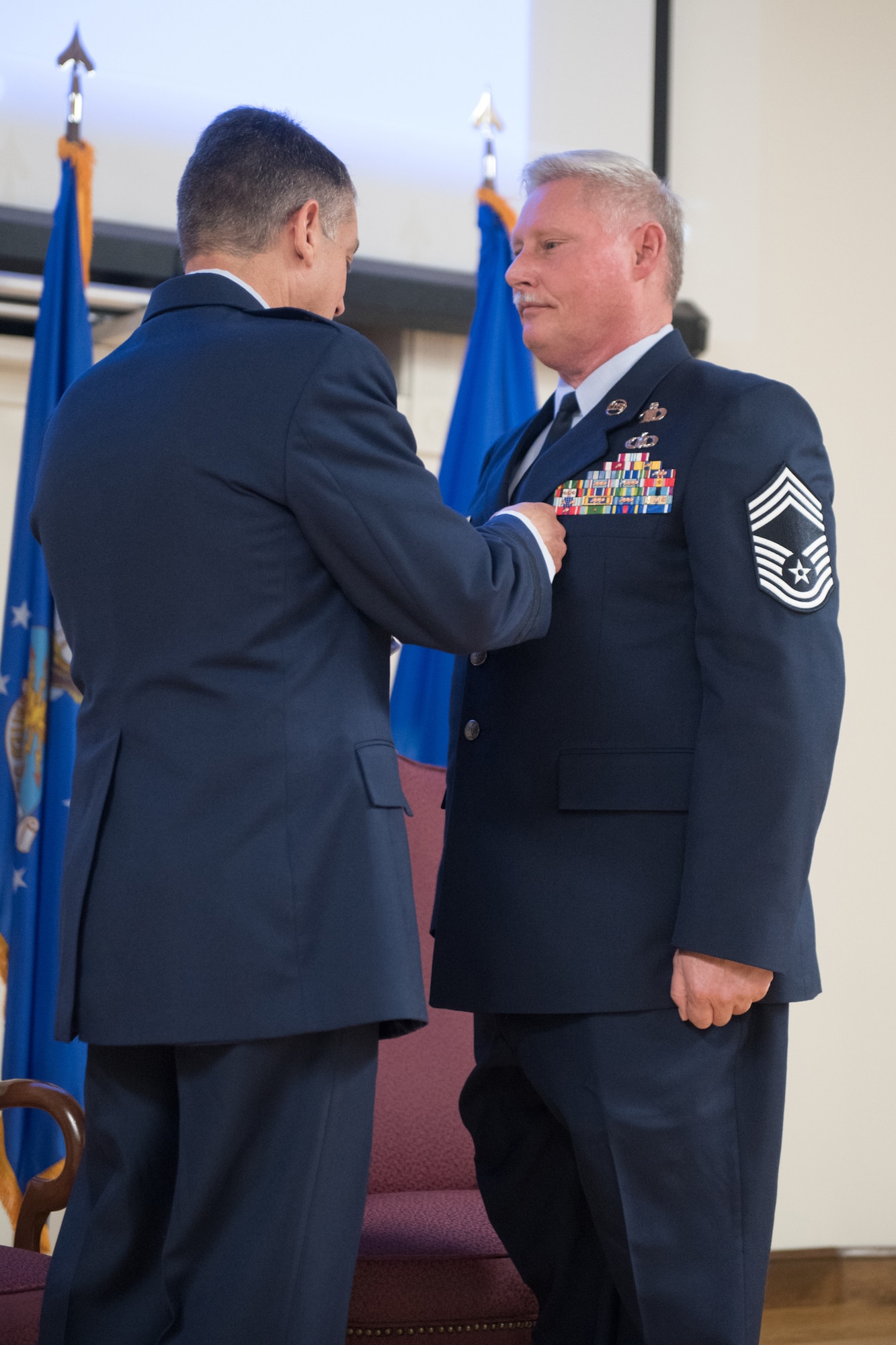 Brig. Gen. Warren Hurst, Kentucky's assistant adjutant general for Air, pins the Meritorious Service Medal on Chief Master Sgt. Joseph E. Atwell Jr. during Atwell’s retirement ceremony at the Kentucky Air National Guard Base in Louisville, Ky., April 15, 2018. Atwell’s career spanned more than 30 years in both the active-duty Air Force and Kentucky Air National Guard. (U.S. Air National Guard photo by Master Sgt. Vicky Spesard)