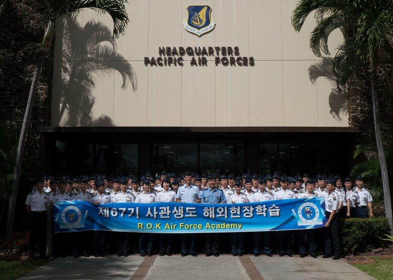 Republic of Korea Air Force (ROKAF) Brig. Gen Seung Bae Kong (center right), ROKAF Academy deputy superintendent and U.S. Air Force Brig. Gen Stephen Williams (right), Pacific Air Forces director of air and cyberspace operations, pose for group photo with ROKAF Academy senior cadets at Joint Base Pearl Harbor-Hickam, Hawaii, June 5, 2018. The visit is an opportunity for the cadets to see how PACAF operates and gain a better understanding of the Indo-Pacific region and the importance of the U.S.-ROK alliance. (U.S. Air Force photo by Staff Sgt. Daniel Robles)