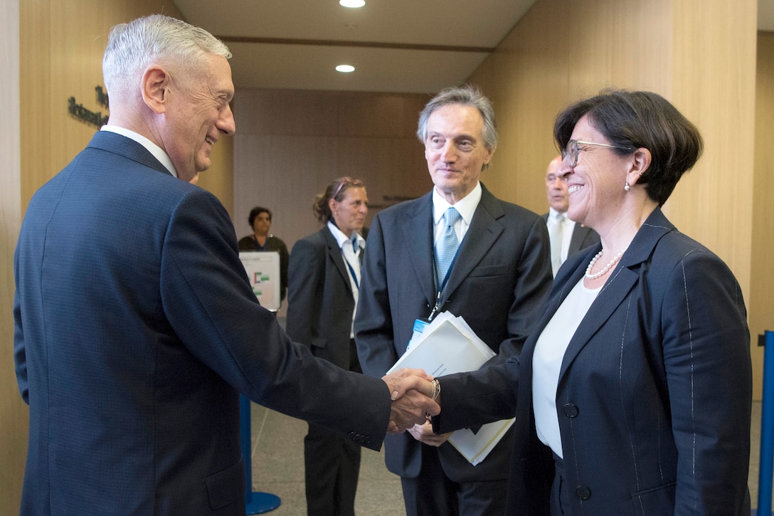 Defense Secretary James N. Mattis shakes hands with the Italian defense minister.