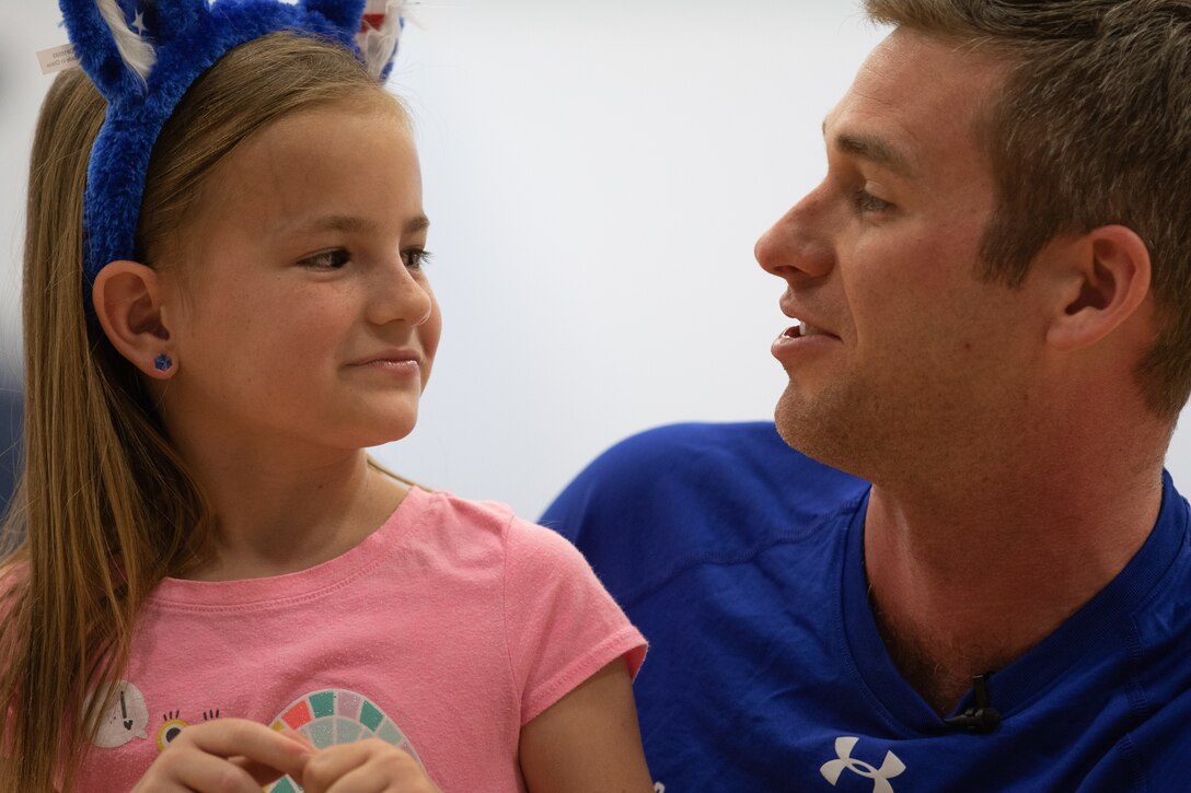 An airman talk with a child.