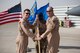 Brig. Gen. Kyle Robinson (left), 332nd Air Expeditionary Wing commander, takes the guidon from Col. William Marshall, 332nd Expeditionary Operations Group commander, during the 332nd EOG change of command, June 8, 2018, at an undisclosed location in Southwest Asia.