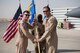 Brig. Gen. Kyle Robinson (left), 332nd Air Expeditionary Wing commander, gives the 332nd Expeditionary Operations Group guidon and command to Col. Bryce Silver during the 332nd EOG change of command, June 8, 2018, at an undisclosed location in Southwest Asia.