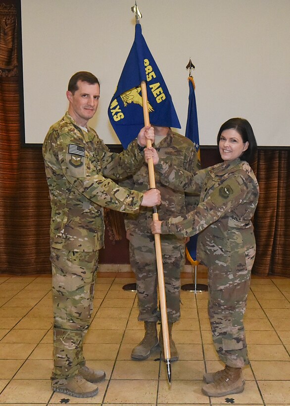 Lt. Col. Tiffany Feet assumes command of the 385th Expeditionary Aircraft Maintenance Squadron by receiving the guidon from Col. Matthew Groves, 385th Air Expeditionary Group commander, during an activation ceremony at Al Udeid Air Base, Qatar, June 6, 2018. (U.S. Air Force photo by Staff Sgt. Enjoli Saunders)