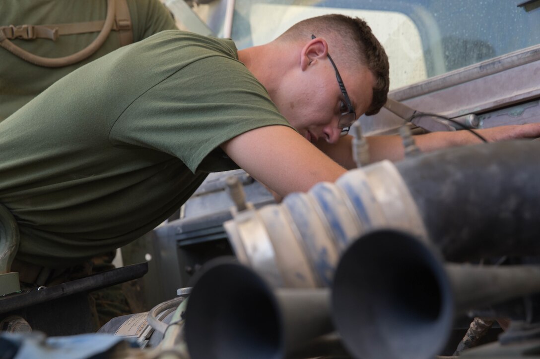 Lance Cpl. Steven Hartley, a motor transport mechanic with Truck Company, 23rd Marine Regiment, 4th Marine Division, conducts maintenance on a Medium Tactical Vehicle Replacement during Integrated Training Exercise 4-18 in Twentynine Palms, California, on June 8, 2018. ITX is the largest annual Marine Forces Reserve training exercise, bringing together over 5,000 Marines from across the United States to prepare battalion and squadron-sized units for combat, under the most realistic conditions possible. (Photo by U.S. Marine Cpl. Dallas Johnson/released)