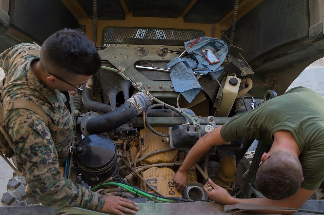 Lance Cpl. Angel Coronado (left) and Lance Cpl. Steven Hartley (right), motor transport mechanics with Truck Company, 23rd Marine Regiment, 4th Marine Division, conduct maintenance on a Medium Tactical Vehicle Replacement to prepare for Integrated Training Exercise 4-18 in Twentynine Palms, California, on June 8, 2018. ITX 4-18 allows Reserve Marines and Sailors to train in realistic environments under realistic conditions, ensuring Marines and Sailors maintain the highest levels of proficiency and readiness for worldwide deployment and the ability to work as a Marine Air Ground Task Force. (Photo by U.S. Marine Lance Cpl. Samantha Schwoch/released)