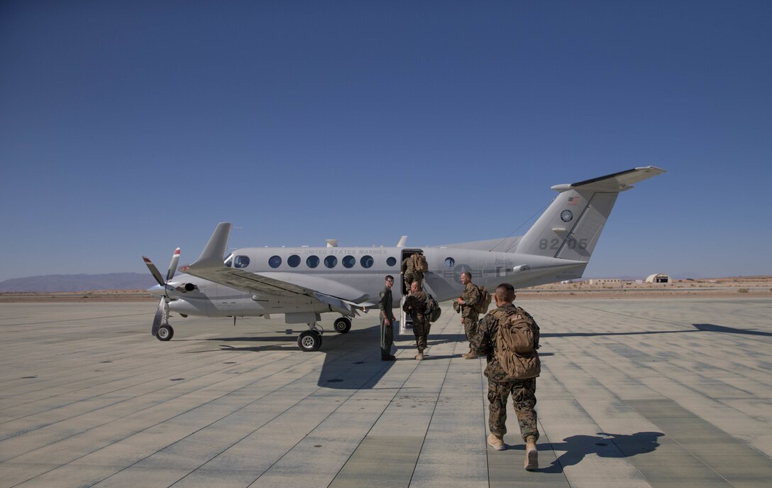 Col. Steven J. White, commanding officer of 23rd Marine Regiment, 4th Marine Division, Sgt. Maj. Ruben Anthony Esparza, sergeant major of 23rd Marines, 4th MarDiv, Col. Matthew F. Amidon, deputy group commander of Marine Aircraft Group 41, 4th Marine Aircraft Wing, and Sgt. Maj. Dallas K. Neel, sergeant major of MAG-41, 4th MAW, embark a U.S. Marine Corps C-12 during Integrated Training Exercise 4-18 in Twentynine Palms, California, on June 9, 2018. Marine Aircraft Group 41 is fulfilling the Air Combat Element role of ITX 4-18, providing essential support to Ground Combat Elements of Marine Air Ground Task Force 23. (Photo by U.S. Marine Corps Lance Cpl. Samantha Schwoch/released)