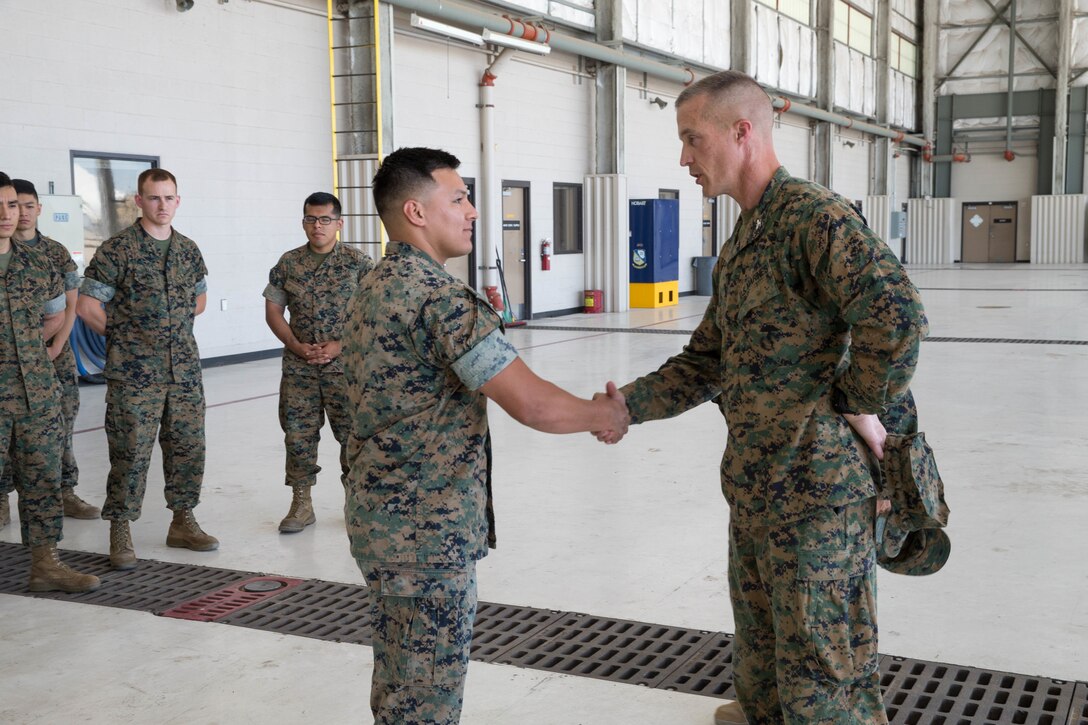 Col. Steven J. White (right), commanding officer of 23rd Marine Regiment, 4th Marine Division, recognizes Cpl. Bryan Reteria, a fixed-wing aircraft safety equipment mechanic with Marine Aerial Refueler Transport Squadron 234, Marine Aircraft Group 41, 4th Marine Aircraft Wing, for outstanding diligence and hard work supporting the squadron year-round, during Integrated Training Exercise 4-18 in El Centro, California, on June 9, 2018. Marine Aircraft Group 41 is fulfilling the Air Combat Element role of ITX 4-18, providing essential support to Ground Combat Elements of the Marine Air Ground Task Force. (Photo by U.S. Marine Corps Lance Cpl. Samantha Schwoch/released)