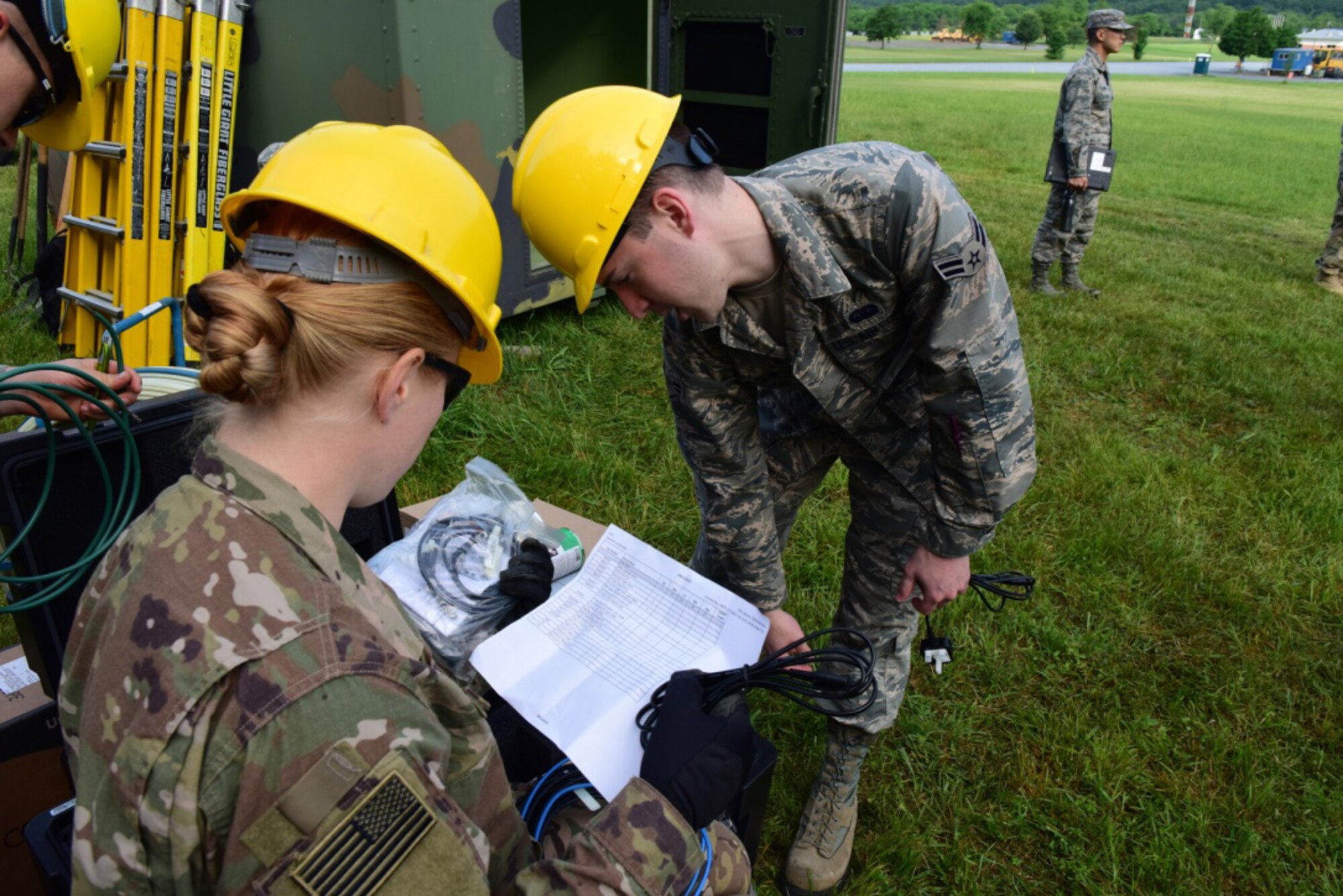 Airmen with the 211th Engineering Installation Squadron, Fort Indiantown Gap, Pennsylvania, check their inventory at the start of the squadron competition June 8, 2018. Checking inventory and starting the generators were the first steps each team took at the beginning of the competition. (U.S. Air National Guard photo by Senior Airman Julia Sorber/Released)