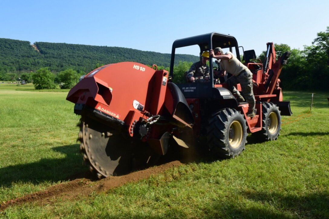 Airmen with the 211th Engineering Installation Squadron, Fort Indiantown Gap, Pennsylvania, dig a trench during the squadron competition June 8, 2018. (U.S. Air National Guard photo by Senior Airman Julia Sorber/Released)