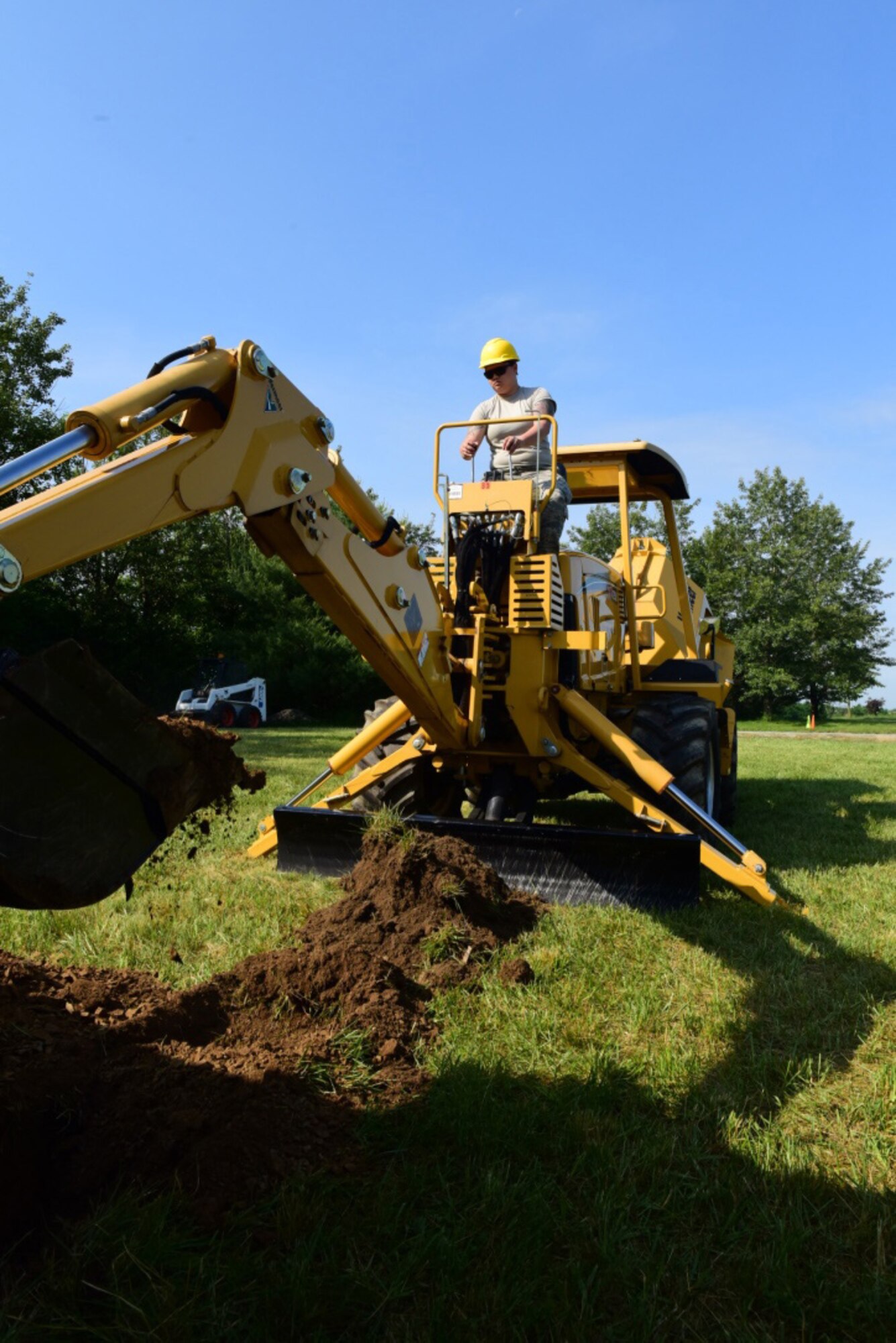 Staff Sgt. Heather Holmes, a cable technician with the 211th Engineering Installation Squadron, Fort Indiantown Gap, Pennsylvania, digs a trench during the squadron competition June 8, 2018. (U.S. Air National Guard photo by Senior Airman Julia Sorber/Released)