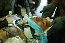 A Navy field medical corpsman with 3rd Medical Battalion, 3rd Marine Logistics Group simulates being a patient during Exercise Inochi No Onjin at Kin Blue, Okinawa, Japan, June 6, 2018. This exercise increased the competency of patient evacuation, command and control, medical regulating, and role-two capabilities of several medical units across the island. The multitude of patient evacuations with cooperation from the Marines, Navy, Army, and Air Force strengthen interoperability between joint services on en-route care. (U.S. Marine Corps photo by Lance Cpl. Harrison Rakhshani)