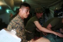 U.S. Navy field medical corpsmen with 3rd Medical Battalion, 3rd Marine Logistics Group provide emergency care to a dummy at Kin Blue, Okinawa, Japan, June 6, 2018. The simulation is part of Exercise Inochi No Onjin, which increased interoperability between joint services on command and control and en-route care. 3rd Med. Bn. is responsible for providing general and direct health service support to III Marine Expeditionary Force. (U.S. Marine Corps photo by Lance Cpl Harrison Rakhshani)