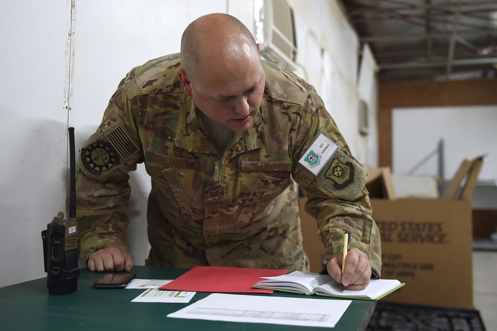 Airman writes in a notebook