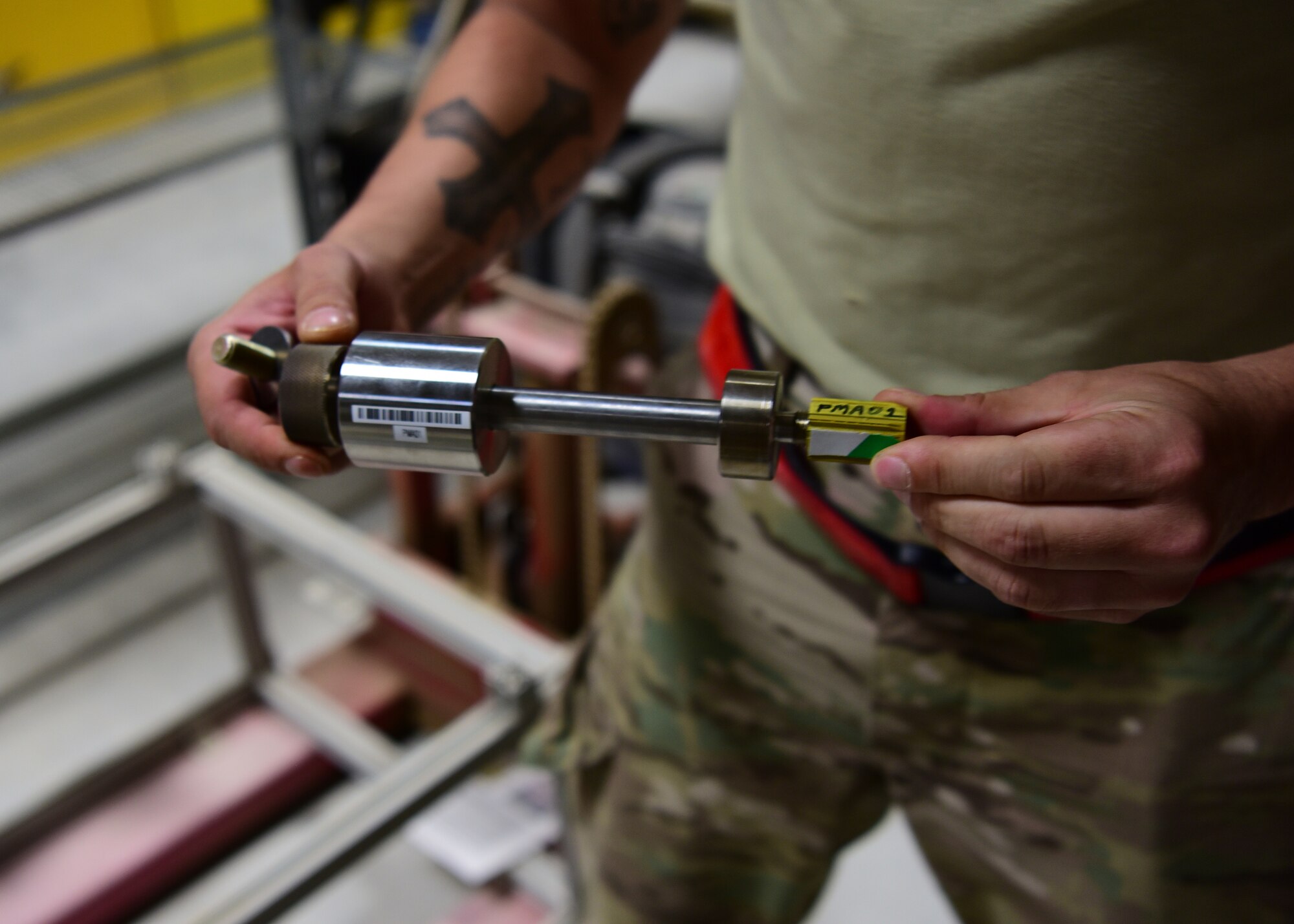 SSgt Hermann Nunez, 386th Expeditionary Aircraft Maintenance Squadron maintainer, holds the revised version of the ‘Spline Insert Extractor,’ which he helped create. (U.S. Air Force photo by Staff Sgt. Christopher Stoltz)
