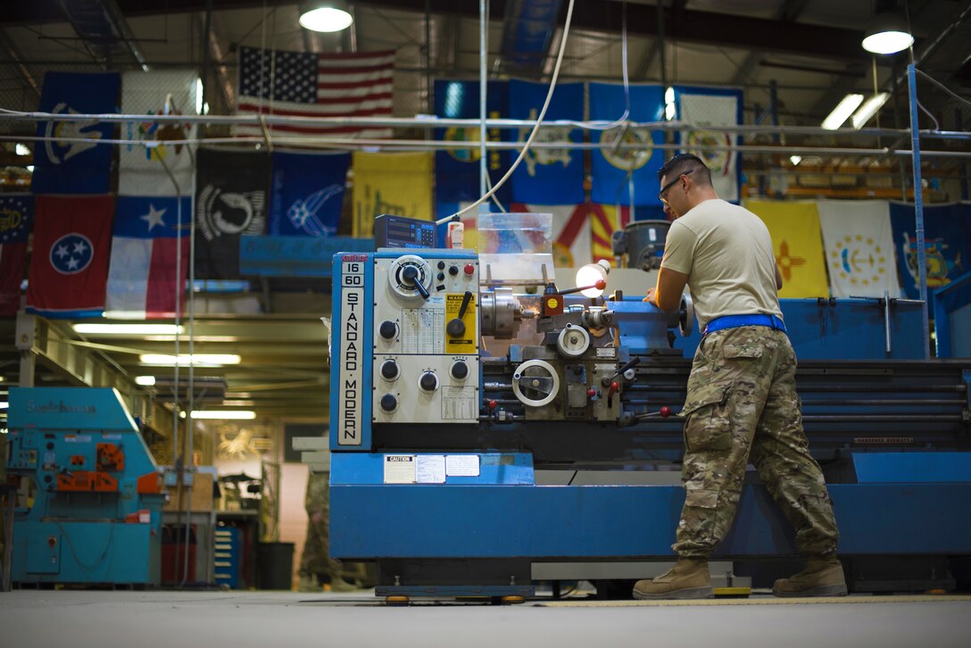 Senior Airman Elio Esqueda, 386th Expeditionary Maintenance Squadron aircraft metals technician, uses a lathe to create a ‘Spline Insert Extractor,’ May 16, 2018, at an undisclosed location in Southwest Asia. The tool was originally created by Tech. Sgt. Chance Cole and Staff Sgt. Hermann Nunez, 386th Air Expeditionary Aircraft Maintenance Squadron. (U.S. Air Force photo by Staff Sgt. Christopher Stoltz)