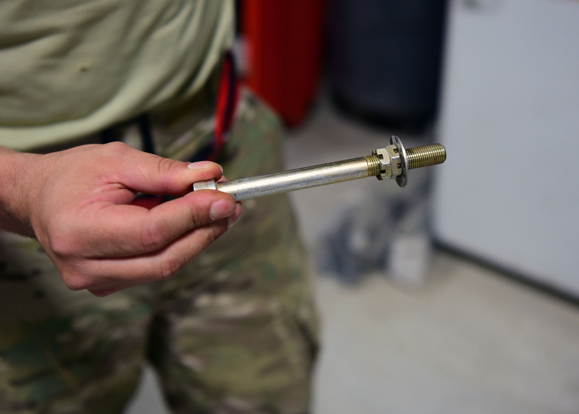 Staff Sgt. Hermann Nunez, 386th Expeditionary Aircraft Maintenance Squadron maintainer, holds the prototype of the ‘Spline Insert Extractor,’ which he helped create. (U.S. Air Force photo by Staff Sgt. Christopher Stoltz)