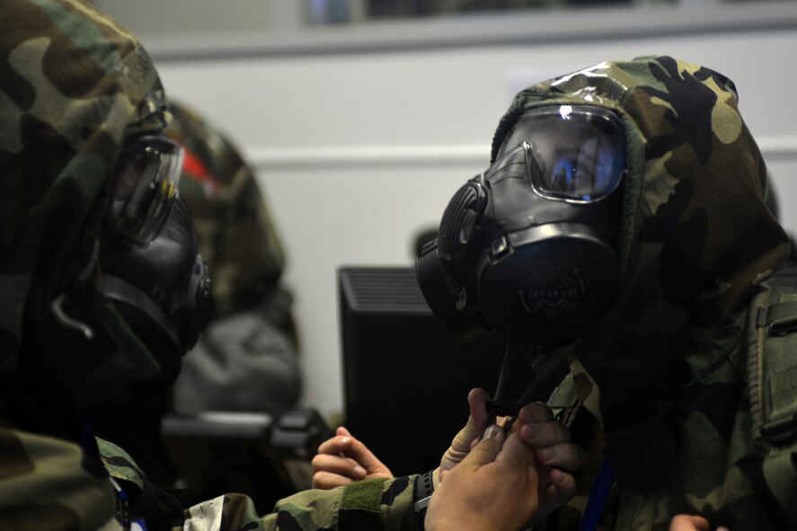 48th Fighter Wing Airmen don mission-oriented protective posture gear during a readiness exercise at Royal Air Force Lakenheath, England, June 4, 2018. Exercise scenarios were designed to emphasize the importance of combat skills effectiveness training and ensure wing Airmen are fully prepared for potential contingencies. (U.S. Air Force photo by Master Sgt. Eric Burks) (Portions of this image have been obscured to protect operational security)