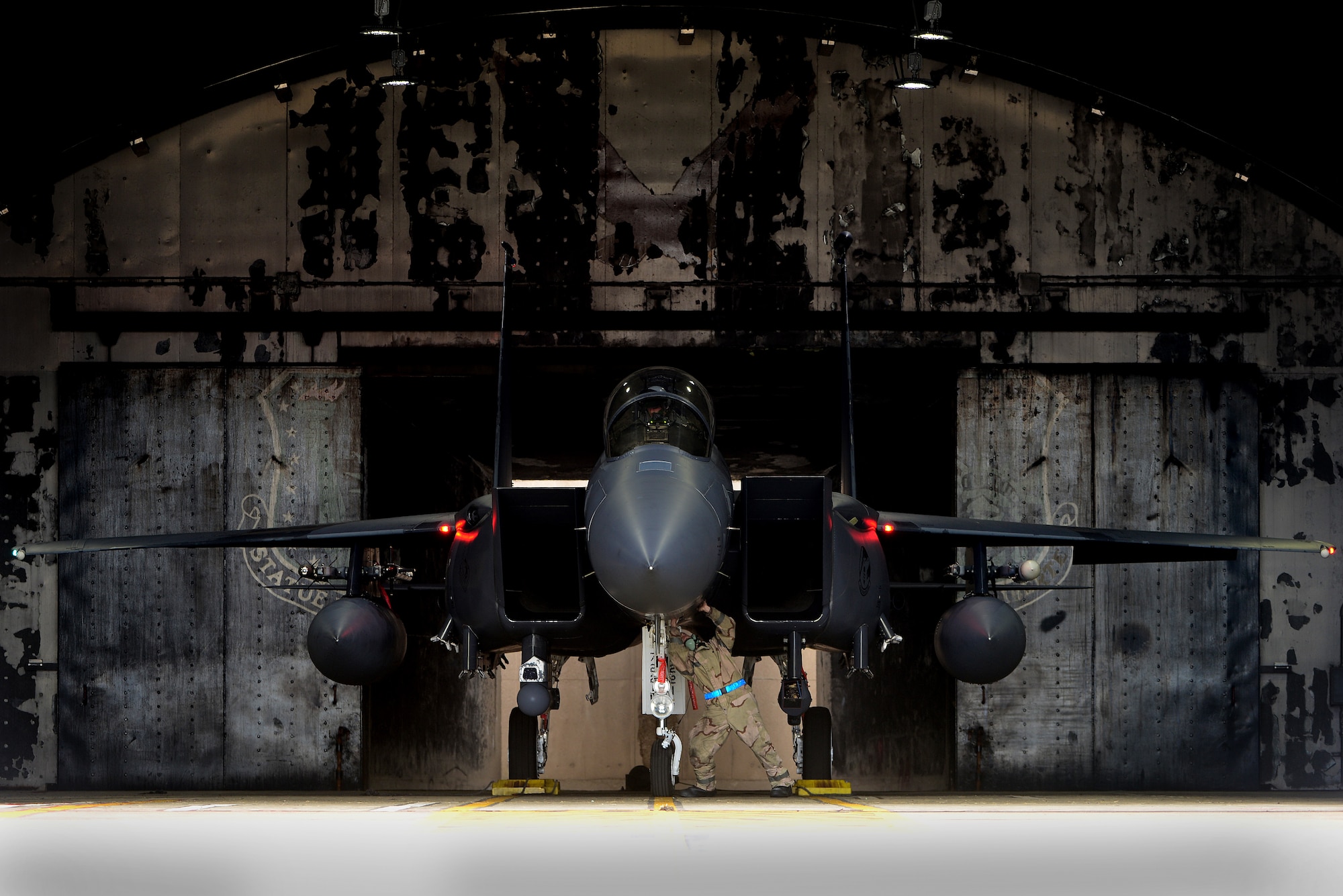 A 48th Fighter Wing maintenance Airman inspects a 492nd Fighter Squadron F-15E Strike Eagle prior to a training sortie during a readiness exercise at Royal Air Force Lakenheath, England, June 5, 2018. Exercise scenarios were designed to emphasize the importance of combat skills effectiveness training and ensure wing Airmen are fully prepared for potential contingencies. (U.S. Air Force photo by Tech. Sgt. Matthew Plew)