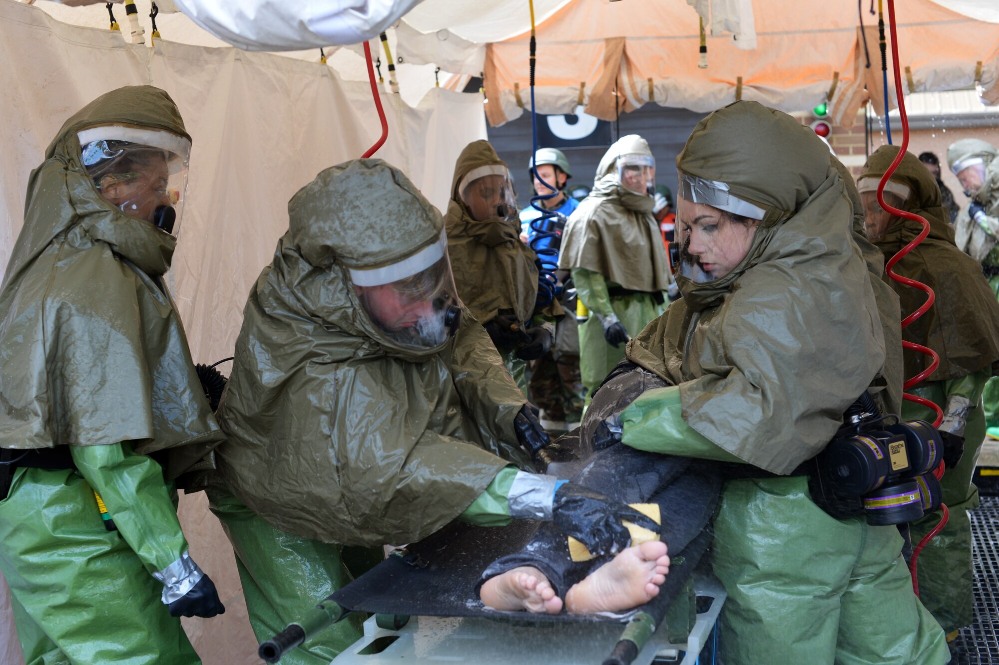 48th Medical Group Airmen decontaminate a patient with simulated injuries following a mass casualty scenario during a readiness exercise at Royal Air Force Lakenheath, England, June 5, 2018. Airmen from the 192nd Medical Group, Virginia Air National Guard, supported the exercise by participating as role players during multiple scenarios. (U.S. Air Force photo by Master Sgt. Eric Burks)