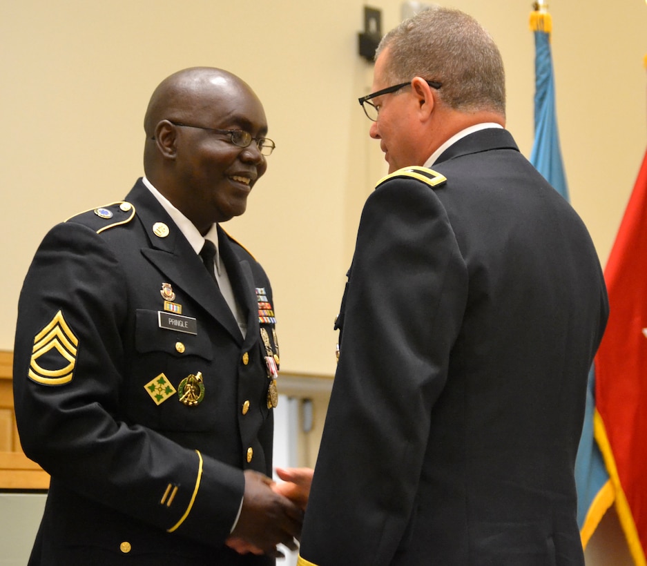 Army Sgt. 1st Class Troy Pringle (left) is congratulated for his retirement by DLA Troop Support Commander Army Brig. Gen. Mark Simerly June 1 in Philadelphia.