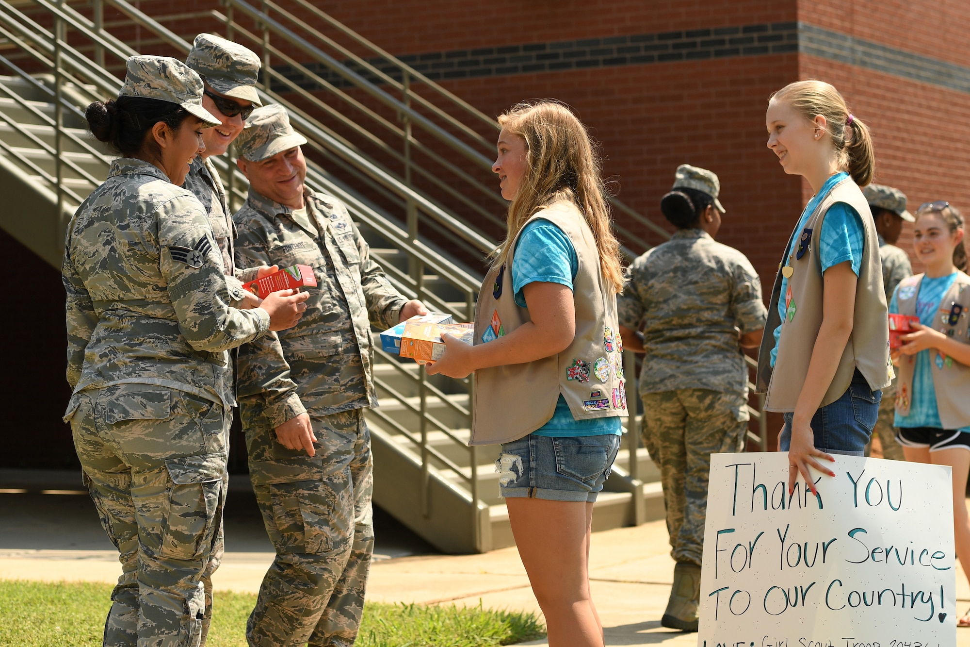 Girl Scouts from Troop 20436 of Denver, N.C., hand out boxes of cookies to Airmen during the fifth annual visit to the North Carolina Air National Guard Base, Charlotte Douglas International Airport, June 9, 2018. Seven Girl Scouts showed appreciation for the military members as they handed out 600 boxes of cookies to Airmen.