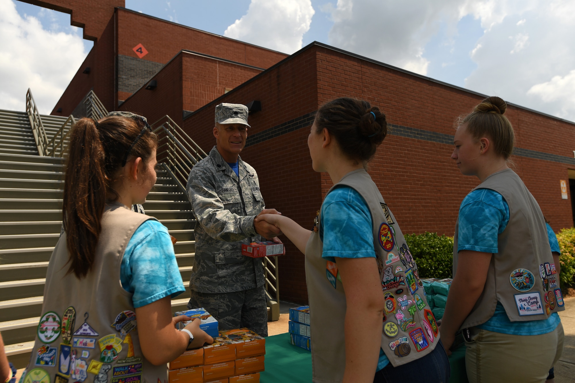 U.S. Air Force Lt. Col. Paul Sanford, 145th Aeromedical Evacuation Squadron, receives a box of cookies from Girl Scouts of Troop 20436, Denver, N.C., as they volunteer during the fifth annual visit to the North Carolina Air National Guard Base, Charlotte Douglas International Airport, June 9, 2018. This is part of a council-wide service project, called Operation Sweet Treat, where Girl Scouts collect cookies to give to U.S. military members serving in the United States and deployed overseas.