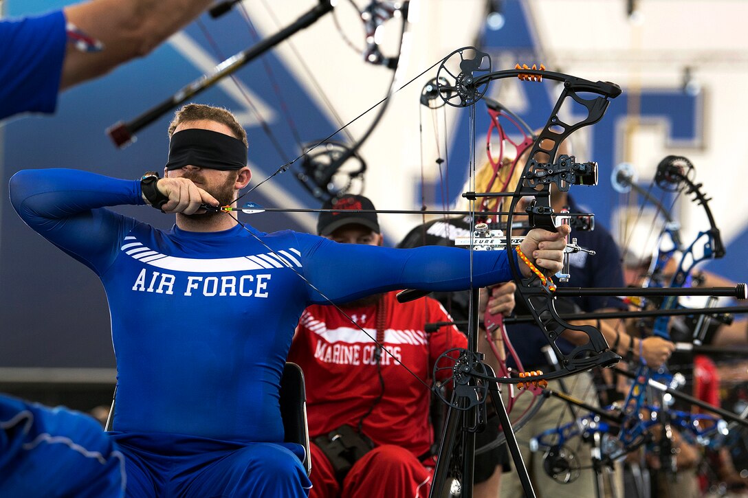 An airman competes in the visually impaired category for archery.