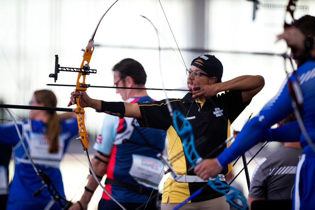 An archer aims at a target.