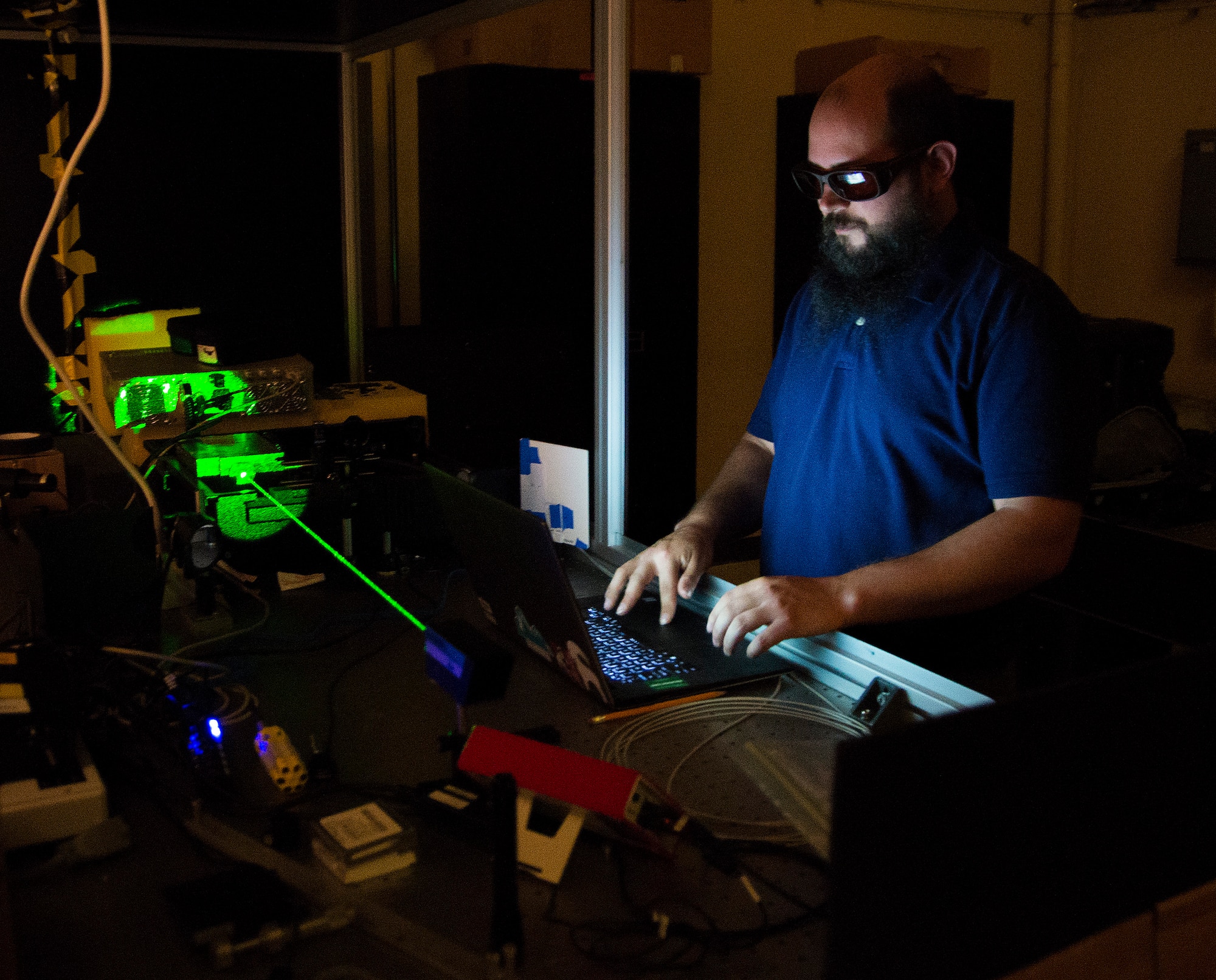 Steve Zuraski, an optical engineer with the Air Force Research Laboratory, works with the Turbulence and Aerosol Research Dynamic Interrogation System, or TARDIS laser in an Air Force Institute of Technology lab at Wright-Patterson Air Force Base, Ohio, June 21, 2017. Zuraski is an AFIT student earning an advanced degree in engineering physics. (U.S. Air Force photo/R.J. Oriez)