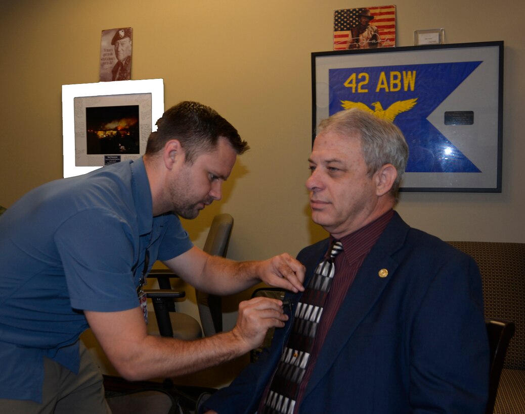 Airman Magazine videographer Andrew Breese attaches a lapel microphone to Rick Bacon, National Security Emergency Preparedness Regional Director/Federal Emergency Management Agency Region VI, prior to  a June 5 interview about Defense Support to Civil Authorities operations. Breese, along with a writer and photographer from the Airman Magazine staff, spent two days with 1st Air Force (Air Forces Northern)-Continental U.S. NORAD Region, for stories about the DSCA mission, along with the mission sets at the 601st Air Operations Center and Air Force Rescue Coordination Center. (Photo by Mary McHale)