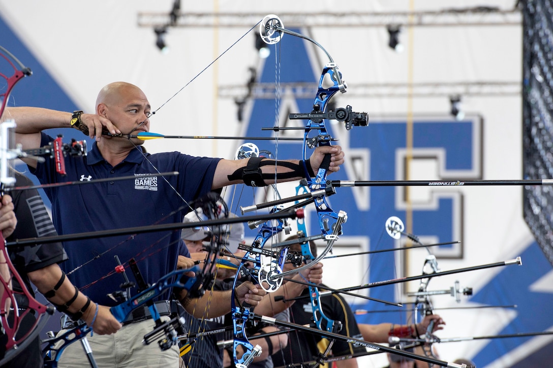 A sailor competes in an archery event.