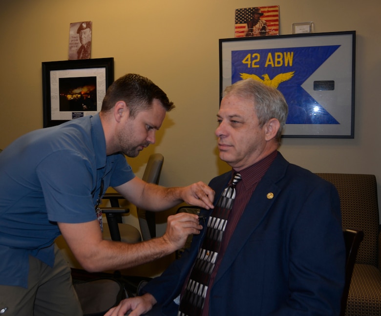 Airman Magazine videographer Andrew Breese attaches a lapel microphone to Rick Bacon, National Security Emergency Preparedness Regional Director/Federal Emergency Management Agency Region VI, prior to  a June 5 interview about Defense Support to Civil Authorities operations. Breese, along with a writer and photographer from the Airman Magazine staff, spent two days with 1st Air Force (Air Forces Northern)-Continental U.S. NORAD Region, for stories about the DSCA mission, along with the mission sets at the 601st Air Operations Center and Air Force Rescue Coordination Center. (Photo by Mary McHale)