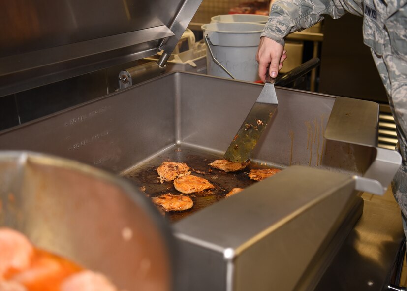 Senior Airman Jeremy Dwyer, 56th Force Support Squadron services supervisor, cooks chicken for the lunch meal at the Hensman Dining Facility June 8, 2018 at Luke Air Force Base, Ariz.
