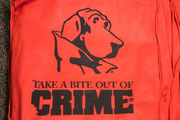 During a visit to the Chavez Child Development Center, McGruff the Crime Dog and other Cannon Air Commandos read books to children and provided bags of material for their children to help keep them safe. Some of the items given were for parents to help identify their children in the case of emergencies. (U.S. Air Force photo by Senior Airman Lane T. Plummer)