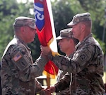 Command Sgt. Maj. Alberto Delgado (left), incoming U.S. Army North command sergeant major, receives the ARNORTH colors from Lt. Gen. Jeffrey Buchanan, commanding general, ARNORTH, during a change of responsibility ceremony at the Quadrangle at Joint Base San Antonio-Fort Sam Houston June 8.