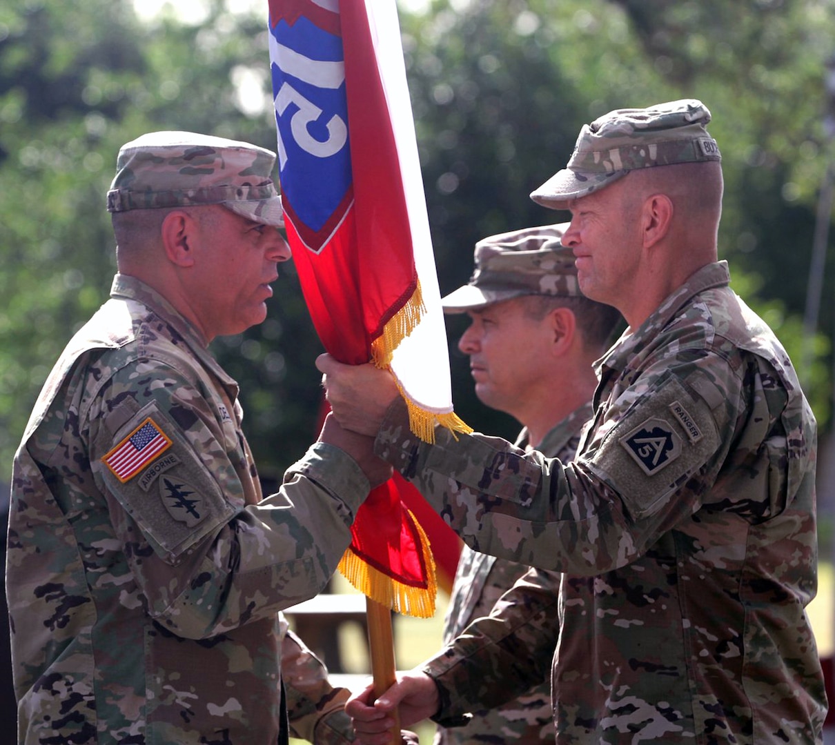 Command Sgt. Maj. Alberto Delgado (left), incoming U.S. Army North command sergeant major, receives the ARNORTH colors from Lt. Gen. Jeffrey Buchanan, commanding general, ARNORTH, during a change of responsibility ceremony at the Quadrangle at Joint Base San Antonio-Fort Sam Houston June 8.