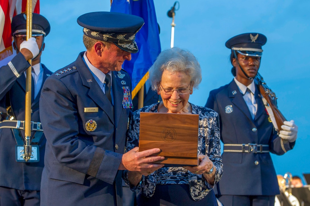 Air Force Chief of Staff Gen. David L. Golden presents a set of Brigadier General stars to Mrs. Doris Day.