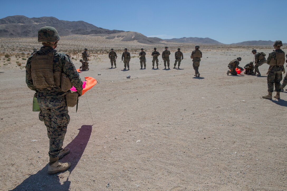 U.S. Marines with Mike Battery, 3rd Battalion, 14th Marine Regiment, set up a casualty evacuation site at a crew-served weapons range exercise during Integrated Training Exercise 4-18 at Marine Corps Air Ground Combat Center Twentynine Palms, California, June 10, 2018. ITX 4-18 provides MAGTF elements an opportunity to undergo a service-level assessment of core competencies that are essential to expeditionary, forward-deployed operations. (U.S. Marine Corps photo by Lance Cpl. Samantha Schwoch/released)