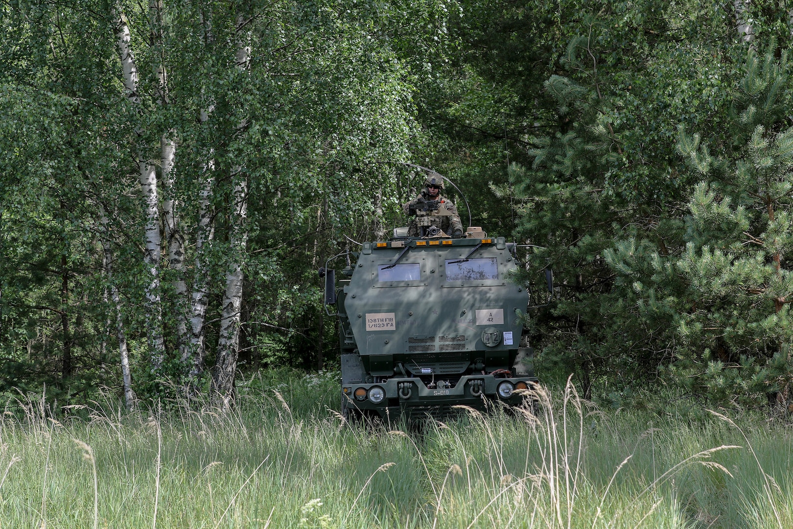 A Soldier assigned to 1st Battalion, 623rd Field Artillery Regiment, Kentucky Army National Guard, waits in his High Mobility Artillery Rocket System (HIMARS) for a fire mission  during the Saber Strike 18 exercise in Kazlu Ruda, Lithuania, on June 10, 2018. Crews of the Kentucky Army National Guard rehearsed no-notice dry-fire drills repeatedly to ensure mastery of their weapons system.