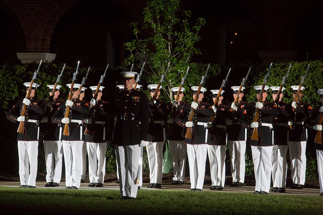 Marines with the U.S. Marine Corps Silent Drill Platoon stand at “port arms” during the Friday Evening Parade at Marine Barracks Washington D.C., June 8, 2018. The hosting official for the parade was U.S. Marine Corps Lt. Gen. Frank McKenzie, director, Joint Staff, and the guests of honor were U.S. Army Lt. Gen. Joseph Anderson, deputy chief of staff for the Army; U.S. Marine Corps Lt. Gen. Brian Beaudreault, deputy commandant, plans, policies and operation; U.S. Navy Vice Adm. Andrew Lewis, deputy chief of operations for operations, plans and strategy; and U.S. Air Force Lt. Gen. Mark C. Nowland, deputy chief of staff for operations. (Official Marine Corps photo by Sgt. Robert Knapp/Released)