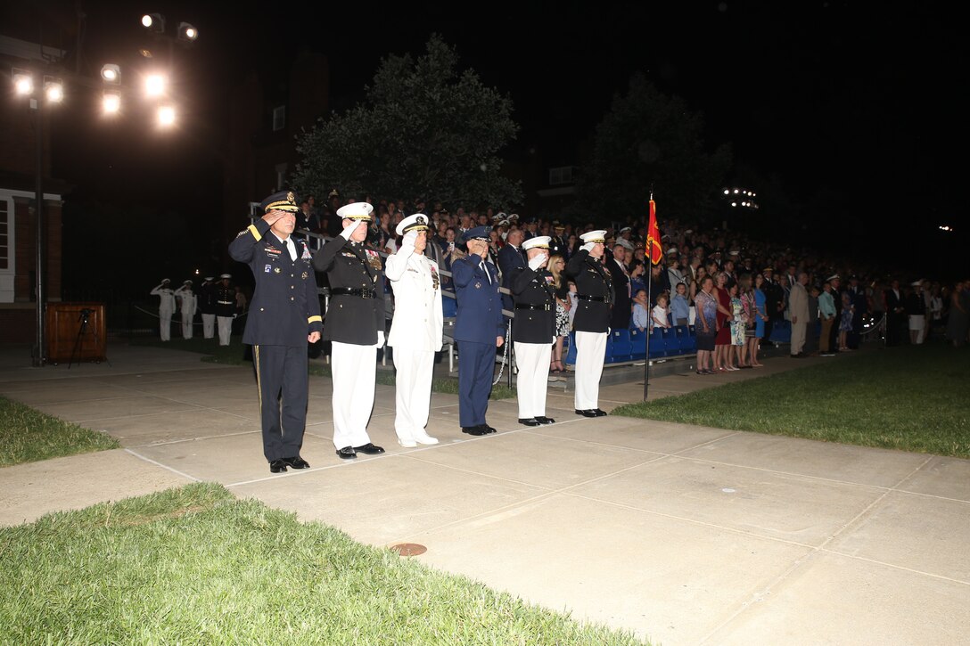 The official party for the Friday Evening Parade renders honors during the ceremony at Marine Barracks Washington D.C., June 8, 2018. The hosting official for the parade was U.S. Marine Corps Lt. Gen. Frank McKenzie, director, Joint Staff, and the guests of honor were U.S. Army Lt. Gen. Joseph Anderson, deputy chief of staff for the Army; U.S. Marine Corps Lt. Gen. Brian Beaudreault, deputy commandant, plans, policies and operation; U.S. Navy Vice Adm. Andrew Lewis, deputy chief of operations for operations, plans and strategy; and U.S. Air Force Lt. Gen. Mark C. Nowland, deputy chief of staff for operations.