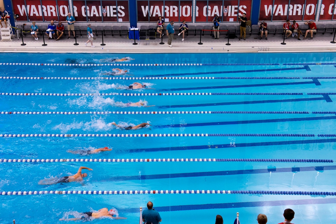 Wounded Warrior Athletes compete in 100-yard freestyle swimming competition.
