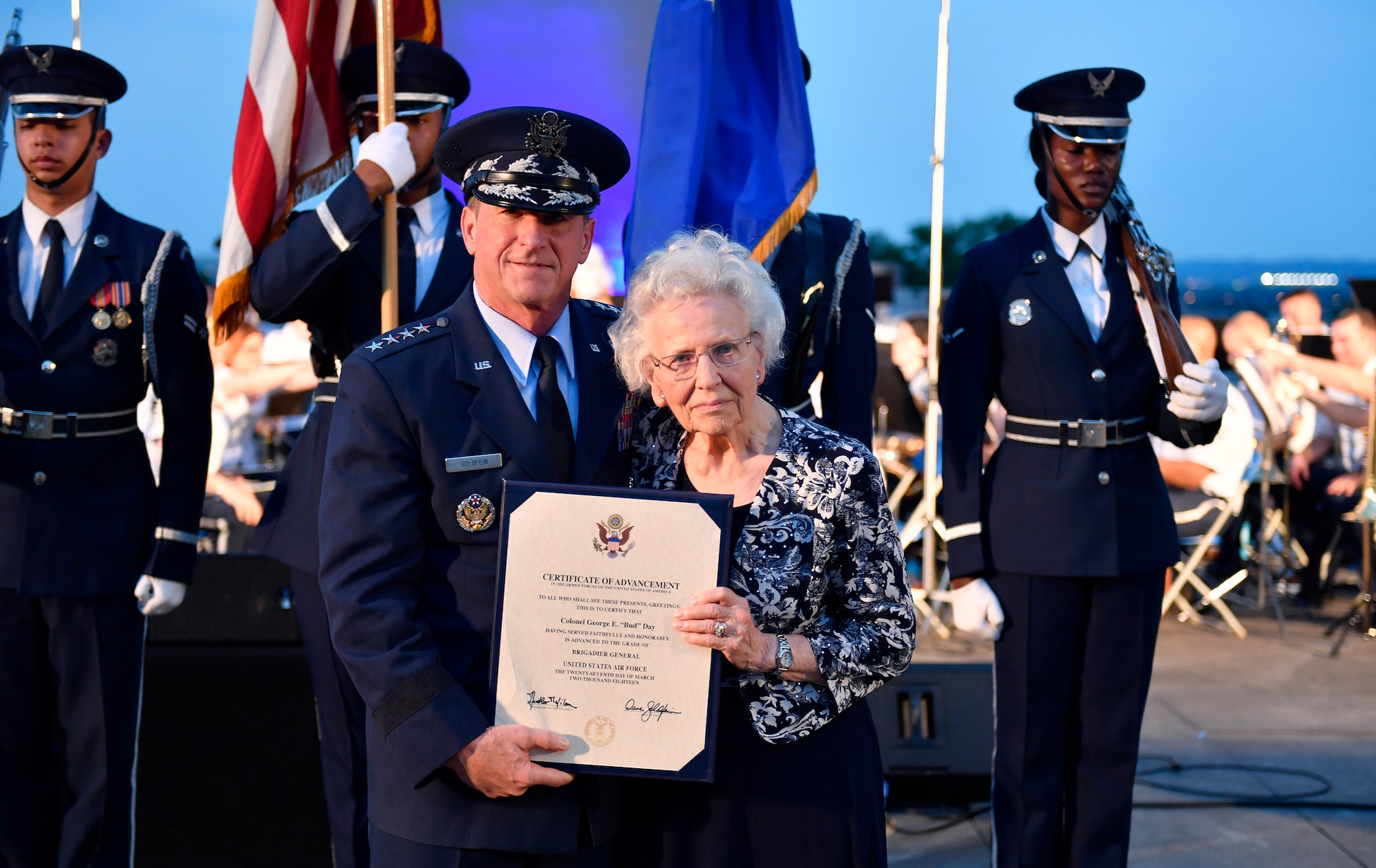 Chief of Staff of the Air Force Gen. David L. Goldfein and Mrs. Doris Day, widow of retired Col. George E. "Bud" Day, accepts the certificate of advancement on behalf of her husband during the 2018 Heritage to Horizons summer concert in Arlington, Va., June 8, 2018.  (U.S. Air Force photo by Wayne A. Clark)
